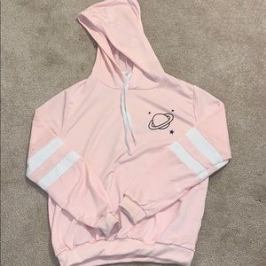 I am selling a light pink and white space hoodie.